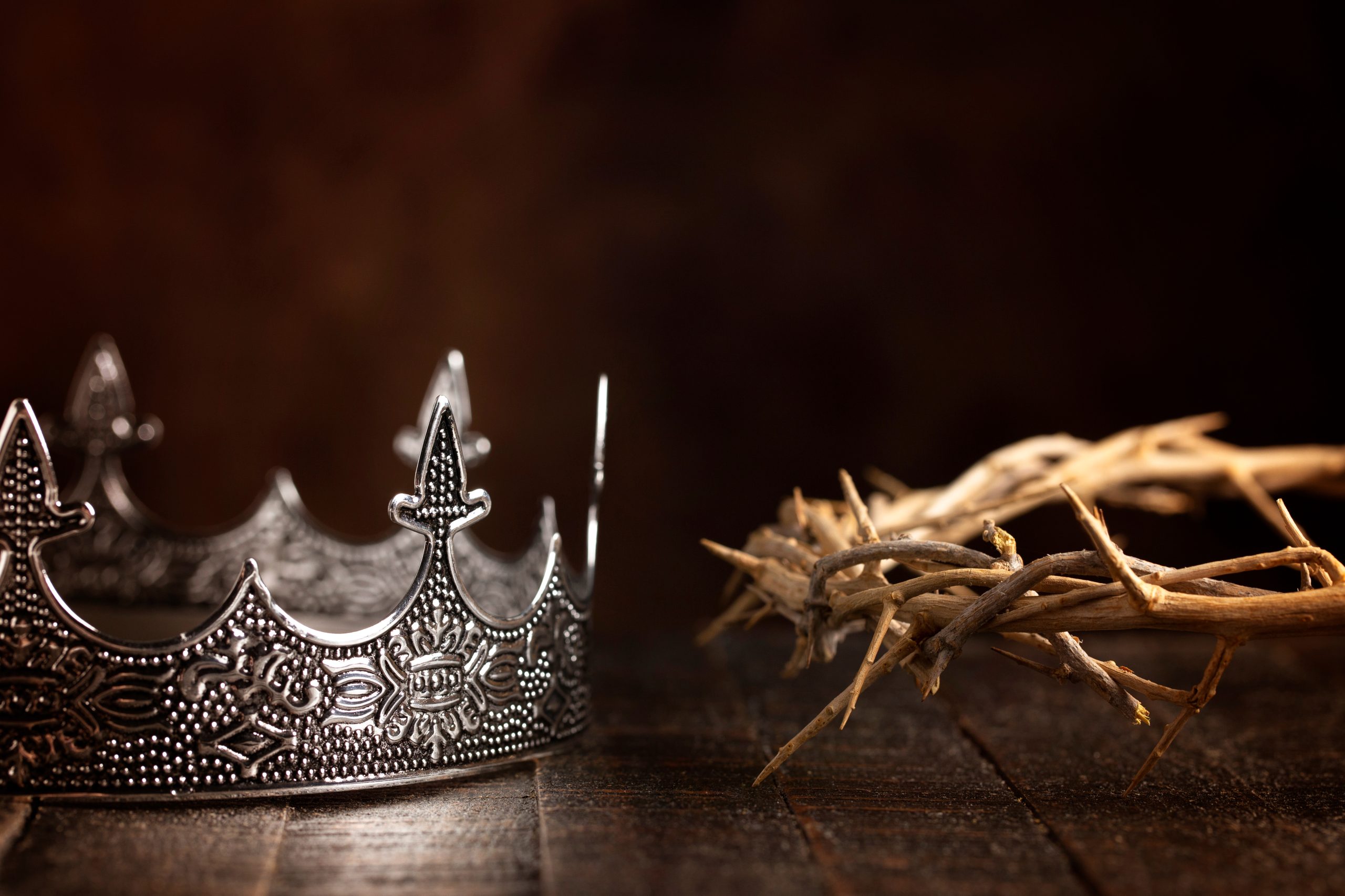 silver crown next to a crown of thorns