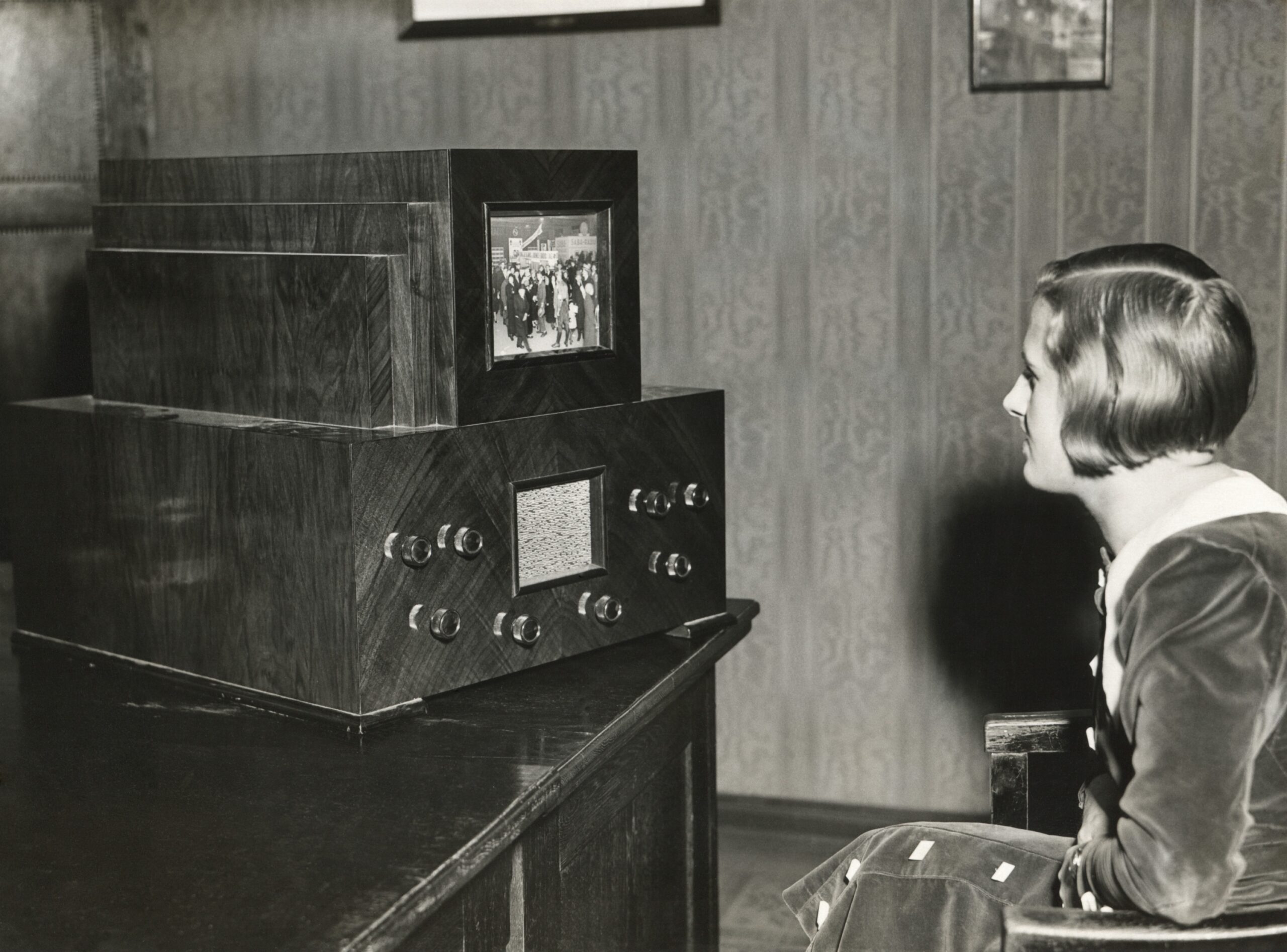 A woman watches television in the 1930s
